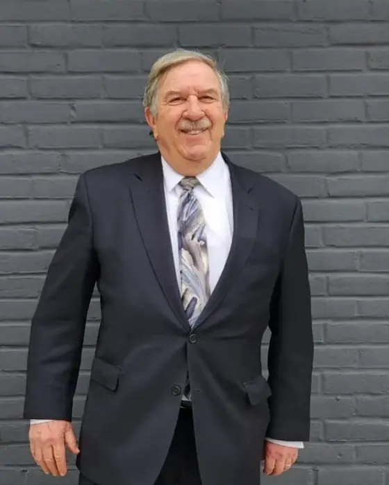 Richard Cary Spivack, attorney at law, standing outside his Forest Hills office